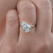 front view of pear-cut diamond solitaire accent engagement ring with yellow gold band