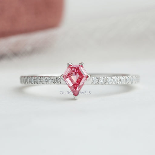 front view of pink kite-cut lab diamond solitaire accent ring on grey fabric