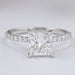 front view of princess cut diamond solitaire accent engagement ring on grey fabric