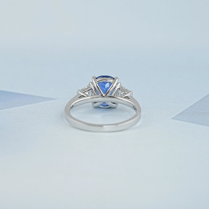 back view of sapphire cushion gemstone with trapezoid diamond 3 stone wedding ring
