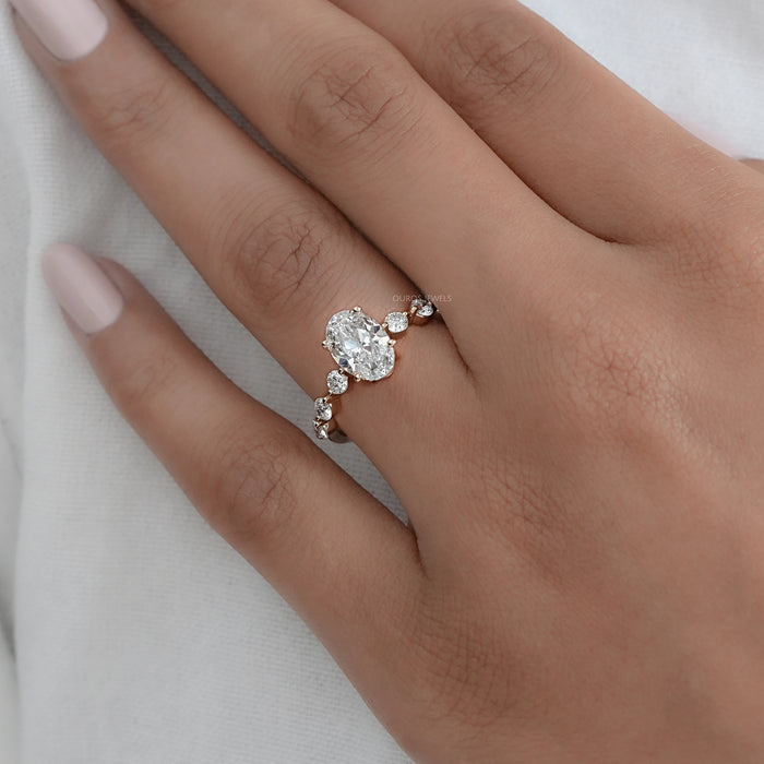 old mine moval cut lab diamond solitaire accent engagement ring in finger