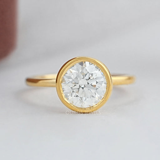 top view of bezel set engagement ring features a large round cut diamond