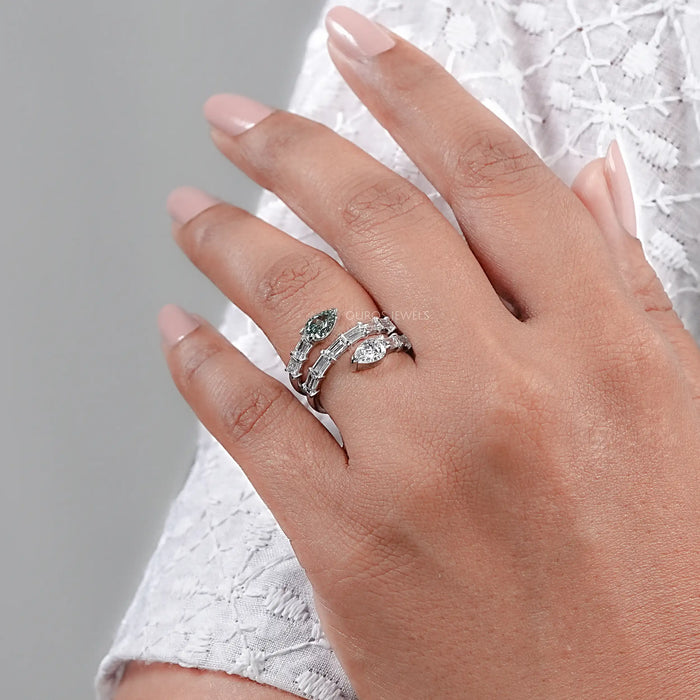 side view of baguette and pear cut diamond spiral colored engagement ring in finger