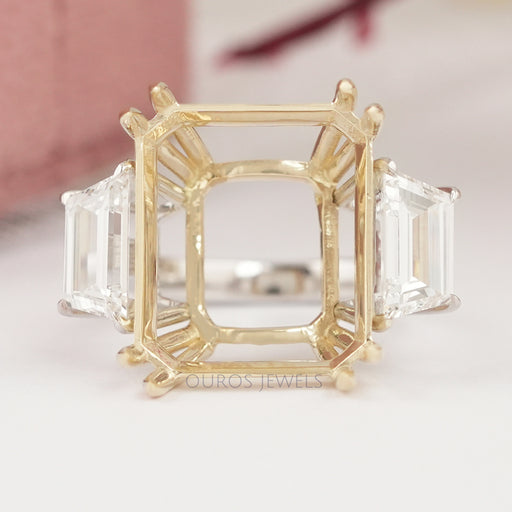 front view of step-cut trapezoid semi-mount three-stone wedding ring on fabric