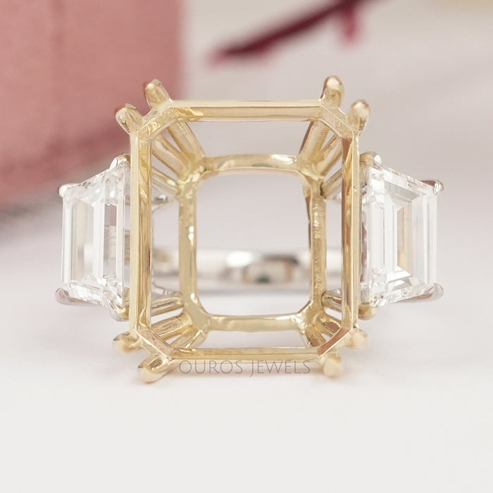 front view of step-cut trapezoid semi-mount three-stone wedding ring on fabric