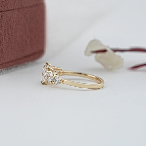 side view of princess cut diamond five stone engagement ring in yellow gold band