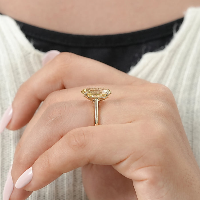 old mine moval yellow diamond solitaire engagement ring in model hand