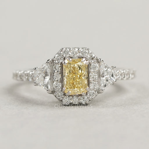 front view of yellow radiant cut diamond three stone halo engagement ring