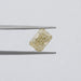 2.15 Carat Fancy Intense Yellow Radiant Cut Lab Diamond hold by tweezers against a plain grey background.