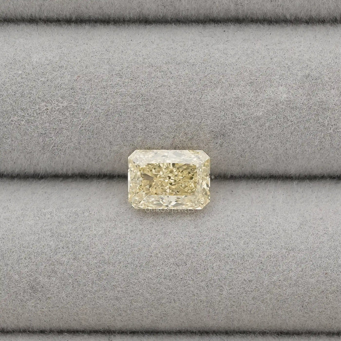 2.15 Carat Fancy Intense Yellow Radiant Cut Lab Diamond displayed on a grey velvet jewelry tray.