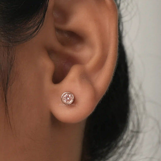 A Women wearing Bezel Set Diamond Stud Earrings.