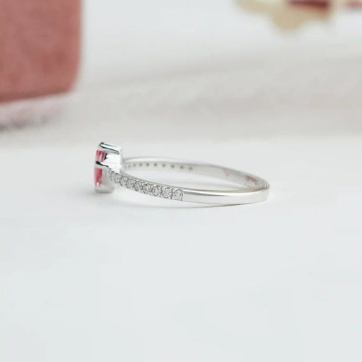 side view of pink kite-cut lab diamond solitaire accent ring on grey fabric