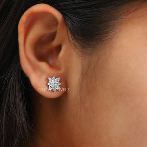 Marquise Cut Cluster Stud Earrings shown worn on an ear, highlighting the sparkling floral design and elegant appearance against the skin.