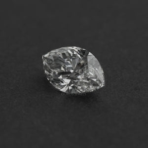 2.50 Carat Marquise Cut Loose Diamond resting on a dark surface, highlighting its intricate facets and clarity.