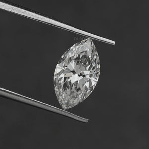 2.50 Carat Marquise Cut Loose Diamond held by tweezers against a dark background, displaying its brilliance.