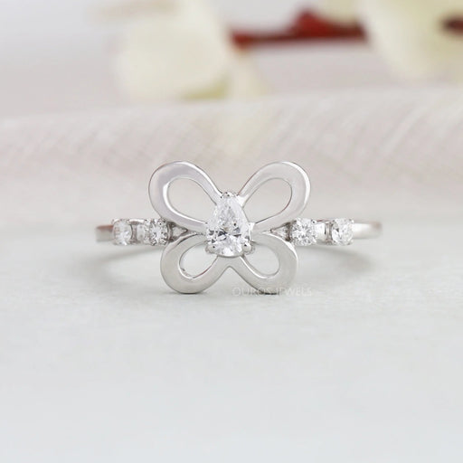 Pear cut butterfly shaped diamond engagement ring with round accent stones and in white gold