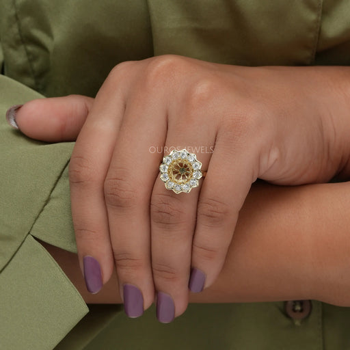 round diamond flower-style bezel round-shaped semi-mount ring on model's finger