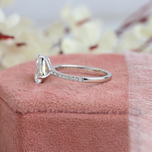 side view of pear and yellow radiant diamond toi et moi wedding ring on jewelry box