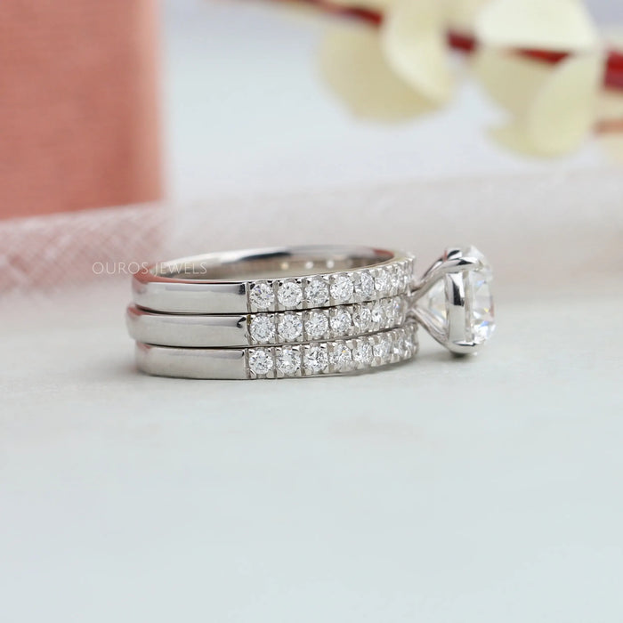 side view of round-cut diamond solitaire 3 bridal ring set with white gold band