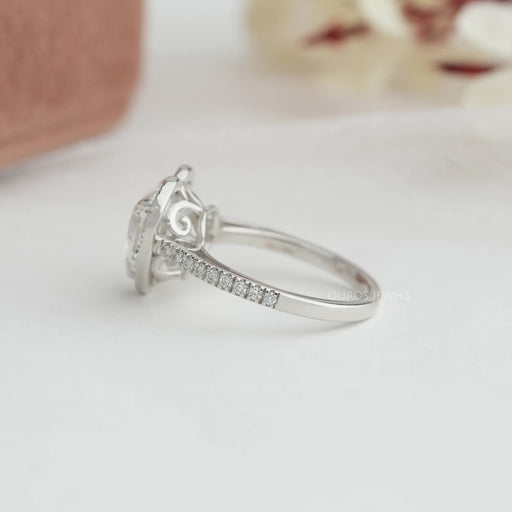 heart cut lab diamond halo engagement ring's side angle view on grey fabric