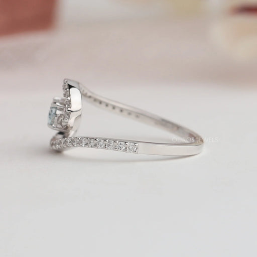 Round stones studded on 14k white gold shank of green oval diamond ring