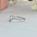 Round diamond studded on 18k white gold shank of diamond curved wedding band