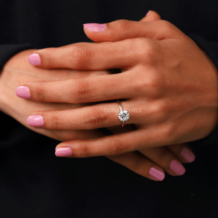 round cut diamond hidden halo solitaire engagement ring on model's hand