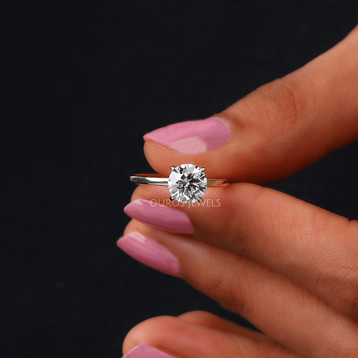 close front view of round diamond hidden halo engagement ring yellow gold band